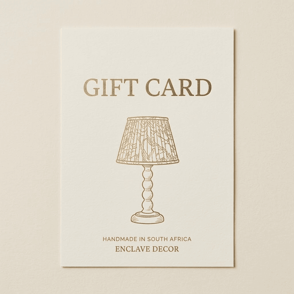 Enclave Decor Gift Card Cream and gold Enclave Decor gift card featuring a bobbin lamp base and pleated lampshade illustration